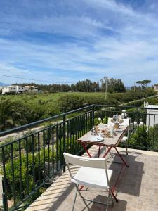 a table and chairs on a balcony with a view at Casa Vacanze Isabella in Campofelice di Roccella