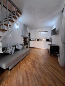 D&P Baia Boccadasse في جينوا: غرفة معيشة مع أريكة وأرضية خشبية