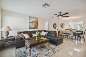 a living room with a couch and a table at Home Near Weeki Wachee, King Bed, Huge Backyard in Spring Hill