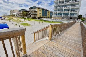 a wooden boardwalk leading to the beach with condos at Caribbean 404 in Gulf Shores