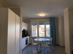 a kitchen with a table and chairs and a window at NUOVO E CENTRALISSIMO in Civitanova Marche