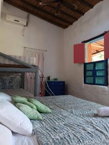 a bedroom with a bed with two pillows on it at La Casa del Mango in Pampatar