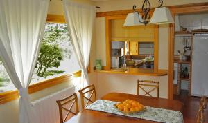 a kitchen with a table with a bowl of oranges on it at La Cerquilla in Segovia