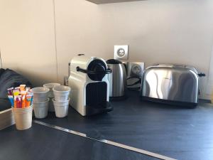 a kitchen counter with a toaster and cups on it at Azur in Fréjus