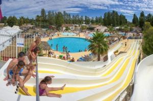 a group of people playing on a slide at a resort at Azur in Fréjus