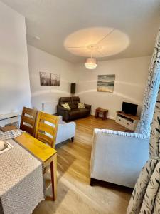 a living room with a couch and a table at The Blue Door in Kirkcudbright