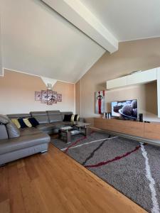Il comprend un salon doté d'un canapé et d'une télévision à écran plat. dans l'établissement Apartments Four You, à Zadar