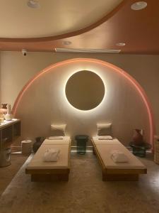 two beds in a room with a circular window at Hôtel D'Anjou in Angers