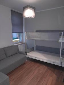 a living room with a couch and bunk beds at Graniczna 8a in Bydgoszcz
