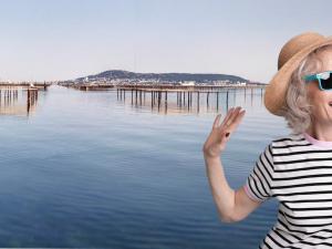 une femme portant un chapeau et des lunettes de soleil debout à côté de l'eau dans l'établissement Studio Balaruc-les-Bains, 1 pièce, 2 personnes - FR-1-503-161, à Balaruc-les-Bains