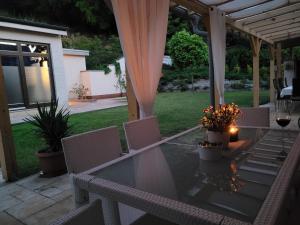 a table and chairs on a patio with a tent at Villa Quality Wellness in Dozmat