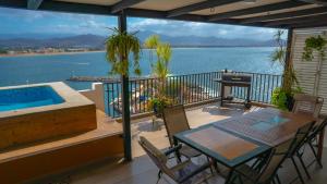a balcony with a table and a swimming pool at Condo in Puerto las Hadas in Manzanillo
