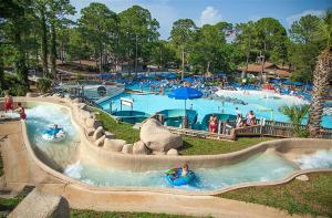 a water park with people in a water slide at Rustic Oasis in Panama City Beach