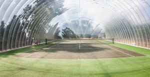 a tennis court in a tunnel with a tennis racket at HAYNE BARN ESTATE - 2 Luxury heated Yurts - private hot tub- private bathroom and kitchen in Hythe