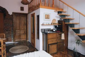 a kitchen with a spiral staircase in a room at Vista Studio Brasov in the Heart of the Old City Center in Braşov