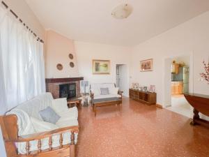 a living room with a couch and a fireplace at Villa in campagna tra natura e verde in Montalto di Castro