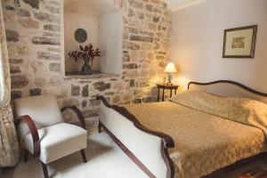 Ένα ή περισσότερα κρεβάτια σε δωμάτιο στο Palazzo Radomiri Heritage Boutique Hotel