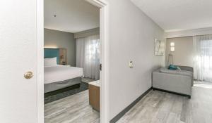 a hotel room with a bed and a bathroom at Courtyard Hampton in Hampton