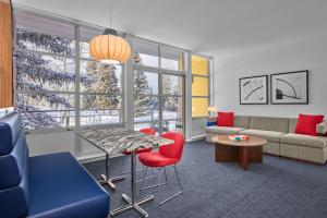 a living room with a couch and a table and chairs at Aspen Meadows Resort in Aspen