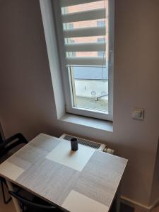 Una mesa en una habitación con ventana en Apartament Wierzbowa 6 z klimatyzacja (air-conditioning), en Poznan