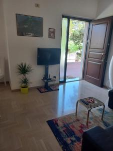 sala de estar con TV y mesa en Casa Stefy Gubbio Centro, en Gubbio