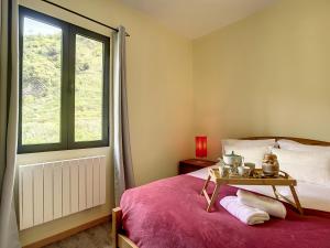 a bedroom with a bed with a table on it at Casa Avo Maria by Atlantic Holiday in São Vicente