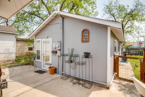 a small white shed with a gate on a patio at Cozy and Convenient San Antonio Home 5 Mi to Dtwn! in San Antonio