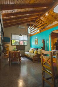 a bedroom with a bed and a blue wall at El Colibrí Cabañas de la Naturaleza in Trelew