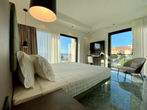 a bedroom with a bed and a large window at Salemare Rooms & Suites in Cefalù
