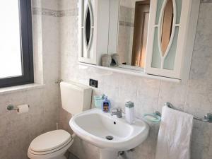 a bathroom with a white toilet and a sink at Vinciguerra Central House Tuscany in Altopascio +47 photos