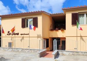 a house with flags in front of it at Le Dune Ground Floor Apartments - Futura CAV in San Vincenzo +46 photos