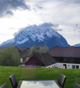 a mountain in the distance with a table and chairs at Apartment Renata Irdning Pichlarn in Aigen im Ennstal