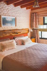 um quarto com uma cama grande num quarto em El Colibrí Cabañas de la Naturaleza em Trelew
