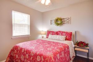 a bedroom with a red bed and a window at Pet-Friendly Vacation Rental with Yard in Canyon in Canyon