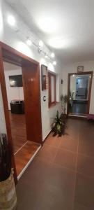 an empty room with a hallway with a door and a room with at Casa Marinela in Baile Felix