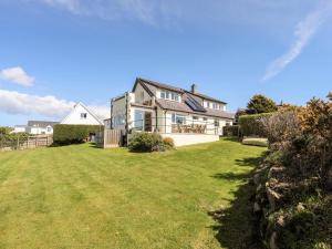 a large house with a large lawn in front of it at Pen Y Garth in Pwllheli