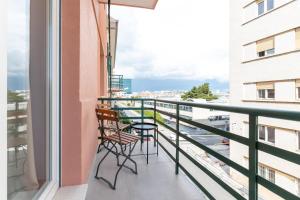 a balcony with chairs and a view of the city at West Coast Deluxe Rooms in Split