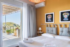 a bedroom with a bed and a balcony at Dream House in Noto +43 photos