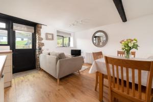 a living room with a couch and a table at Kingfisher Cottage at Robin Hill 4 in Bideford
