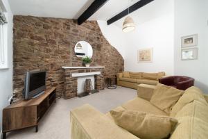 a living room with a couch and a fireplace at Puffin Cottage at Robin Hill 6 in Bideford