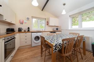 a kitchen with a table and chairs in a kitchen at Puffin Cottage at Robin Hill 6 in Bideford