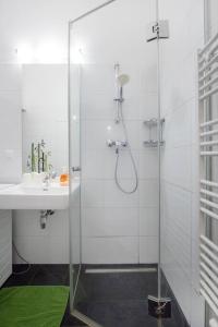 a bathroom with a glass shower and a sink at Relax Apartment Vienna City Center in Vienna