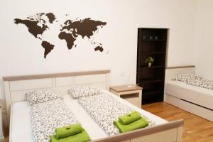 a bedroom with two beds and a world map on the wall at Relax Apartment Vienna City Center in Vienna +28 photos