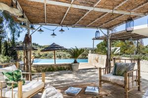 a patio with chairs and a view of a pool at Dream House in Noto
