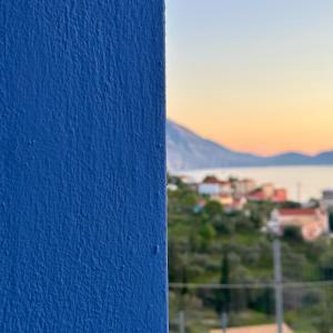 a blue wall with the sunset in the background at Assos BLUE house in Asos