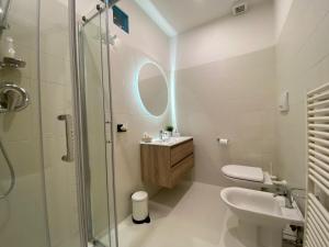 a bathroom with a shower and a sink and a toilet at Garibaldi 36 Apartament in San Giovanni Valdarno +12 photos