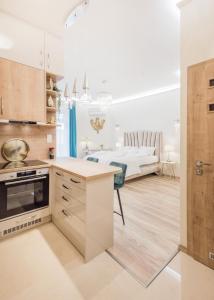 a kitchen and living room with a bed in the background at Shining Feather Studio in Budapest