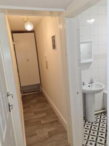 a small bathroom with a sink and a toilet at The Lawrence apartment in Bristol