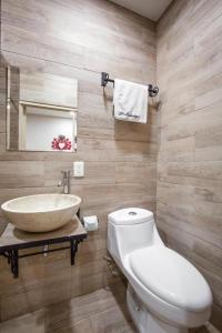 a bathroom with a sink and a toilet at Hotel El Andariego in Oaxaca City +31 photos
