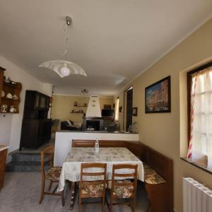a dining room and kitchen with a table and chairs at Casa delle azalee in Gravellona Toce
